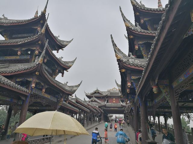 Timber shop-houses with upturned tiled eaves along a street in Huanglongxi